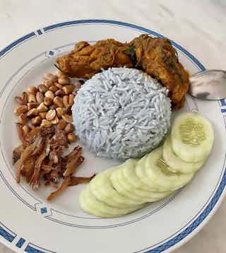 Nasi Lemak with blue rice,rendang chicken,anchovies,peanuts,cucumbers
